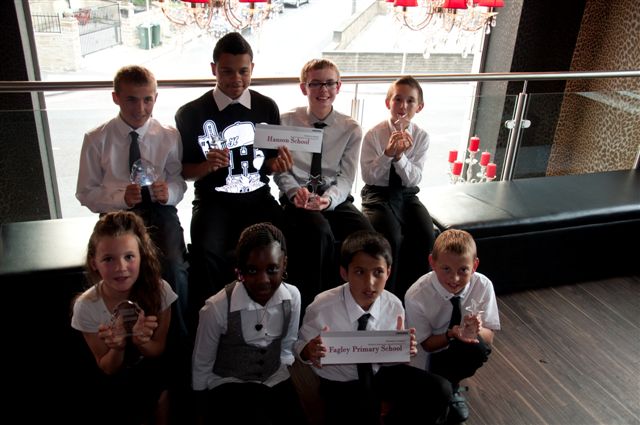 Students from a local school being awarded with their trophies.